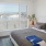 a bedroom with a view of the city