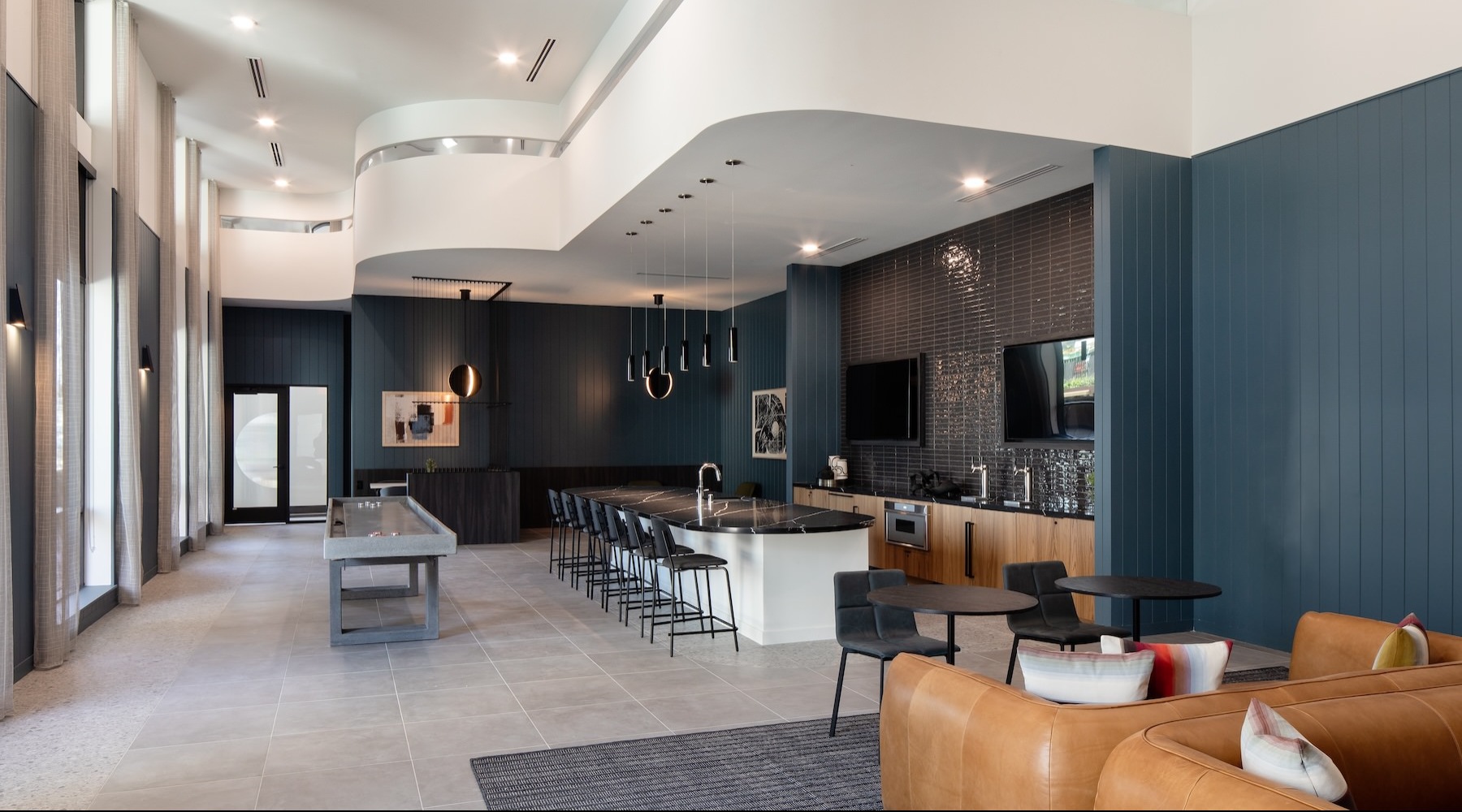 Everything within reach a room with a pool table and seating and large windows