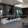a kitchen with a bar and chairs