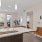 a kitchen and living area with large windows